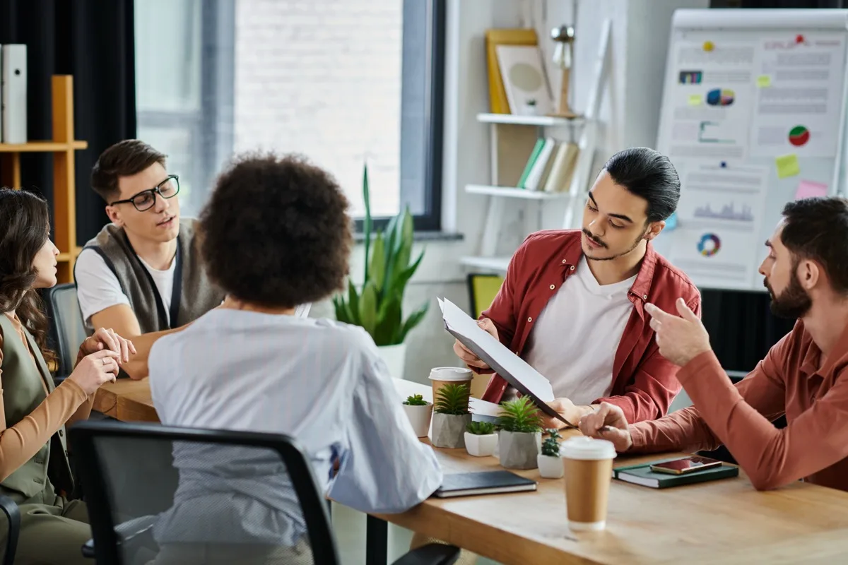 Coworkers talking together during a supportive workplace wellbeing check-in.