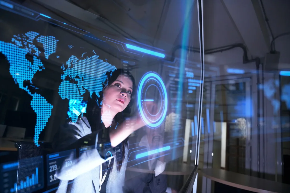 A professional using a futuristic digital dashboard to analyse workforce skills and performance data.